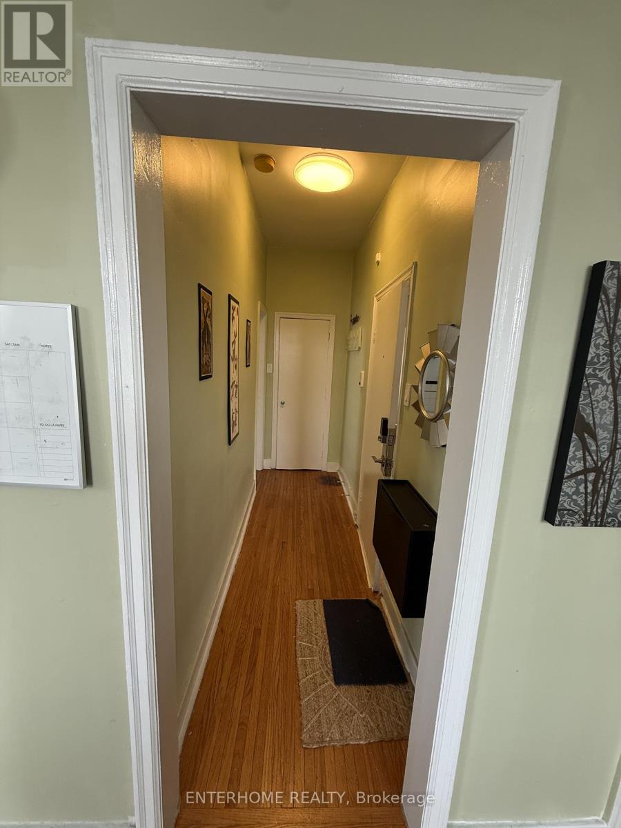 A hallway with a brokerage sign on the door.
