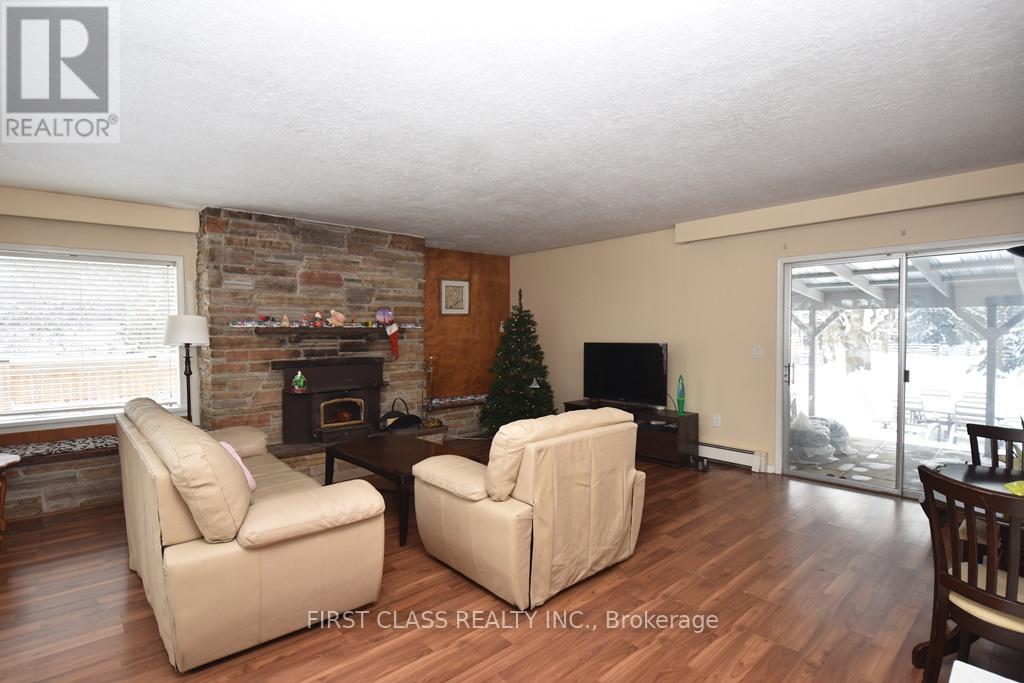 A living room with a fireplace and a Christmas tree.