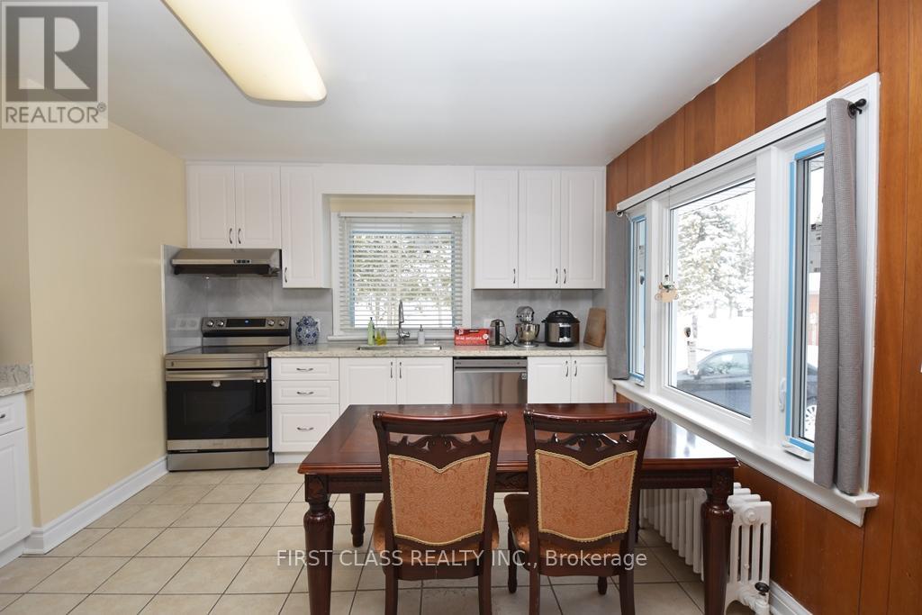 A kitchen with a table and chairs in the foreground.