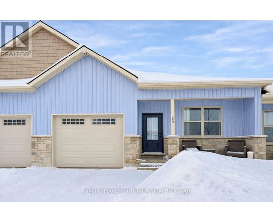 A blue house with a black door and two garages.