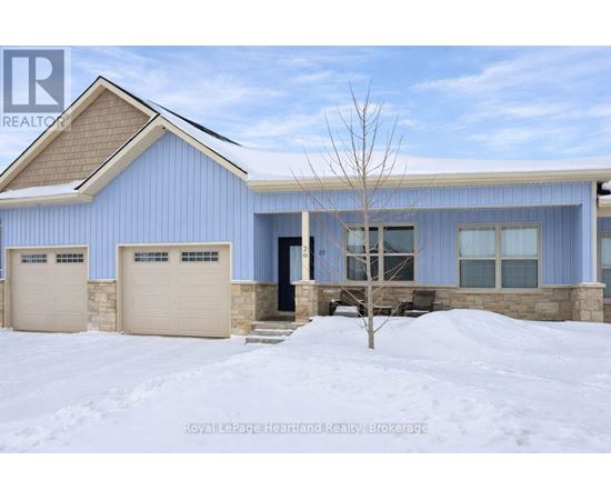 A blue house with a brown roof and two garages.
