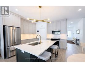 A modern kitchen with a stainless steel refrigerator and a white countertop.