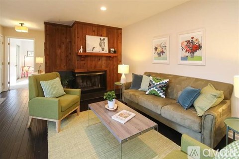 A living room with a couch, chair, and coffee table.