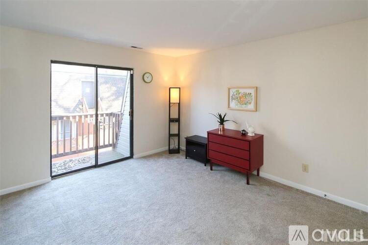 A room with a red dresser and a painting on the wall.