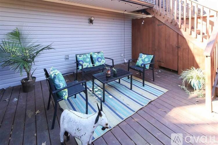 A wooden deck with a table and chairs.