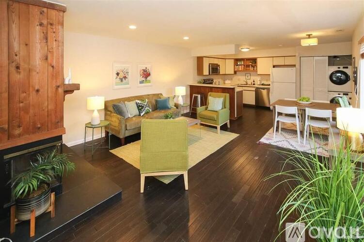 A living room with a couch, chairs, and a fireplace.