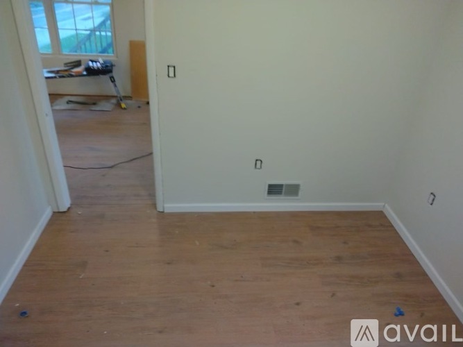 A room with wooden floors and white walls.