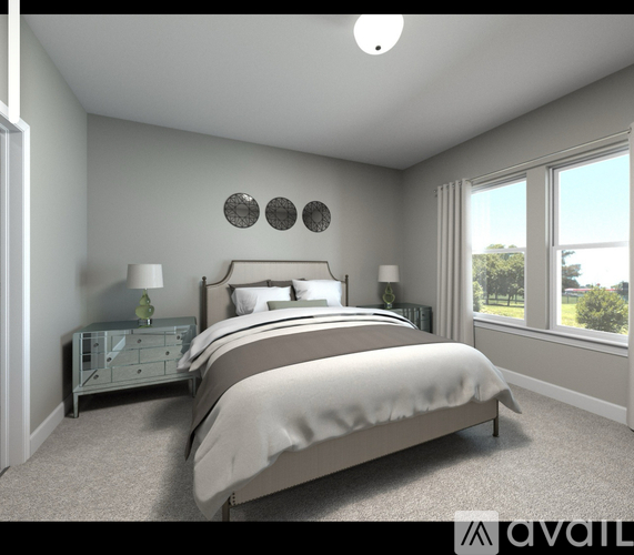 A bedroom with a large bed and a nightstand with a lamp.