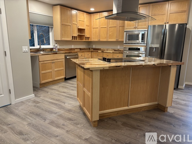 A kitchen with wooden cabinets and a central island.