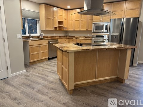 A kitchen with wooden cabinets and a central island.