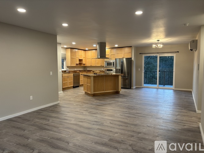 A spacious kitchen with wooden cabinets and a large island.