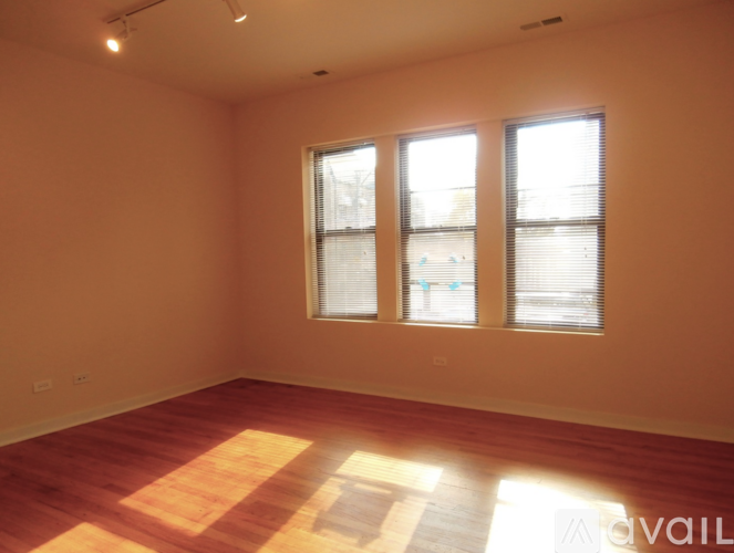 A room with wooden flooring and a white door.