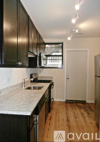 A kitchen with black cabinets and a sink.