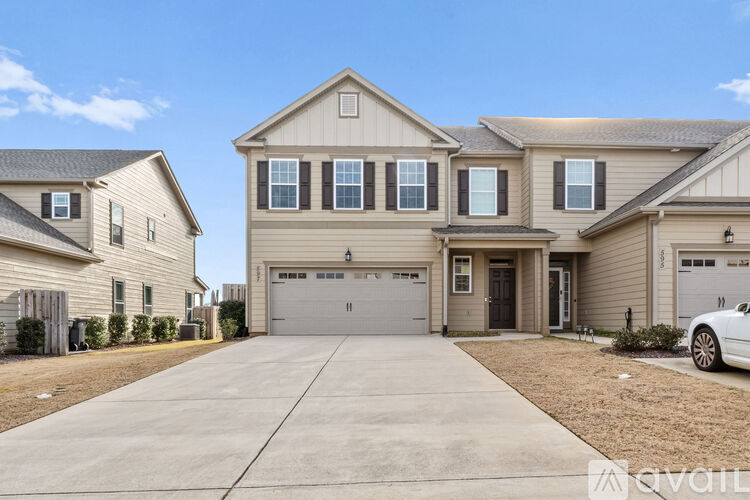 A two-story house with a garage is available for sale.