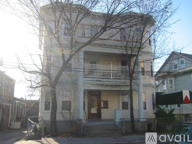 A two-story building with a balcony on the second floor.