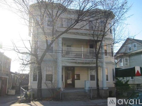 A two-story building with a balcony on the second floor.