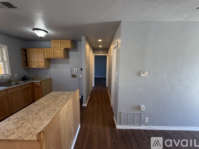 A kitchen with wooden cabinets and a countertop.