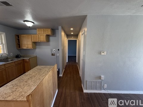 A kitchen with wooden cabinets and a countertop.