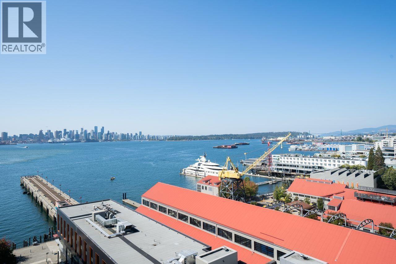 A view of a city from a high vantage point with a red roofed building in the foreground.