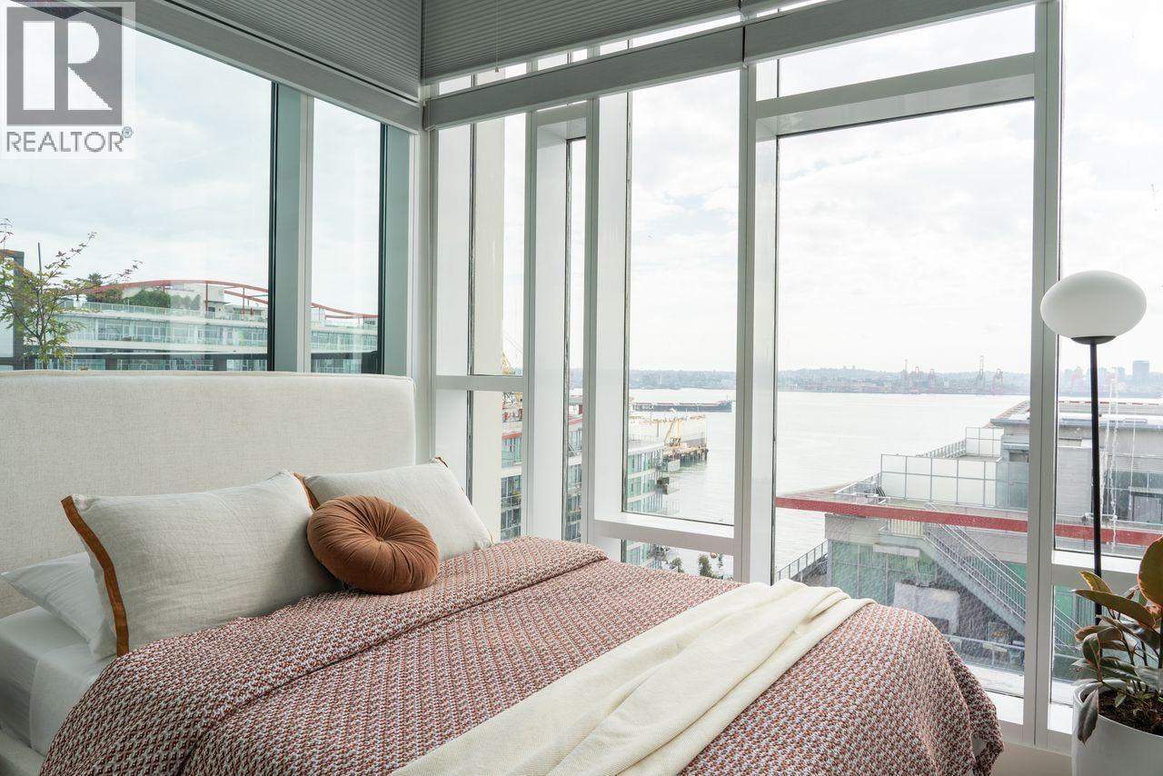 A bedroom with a large bed and a view of the city.