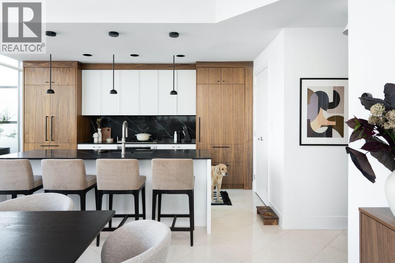 A modern kitchen with a dining table and chairs.