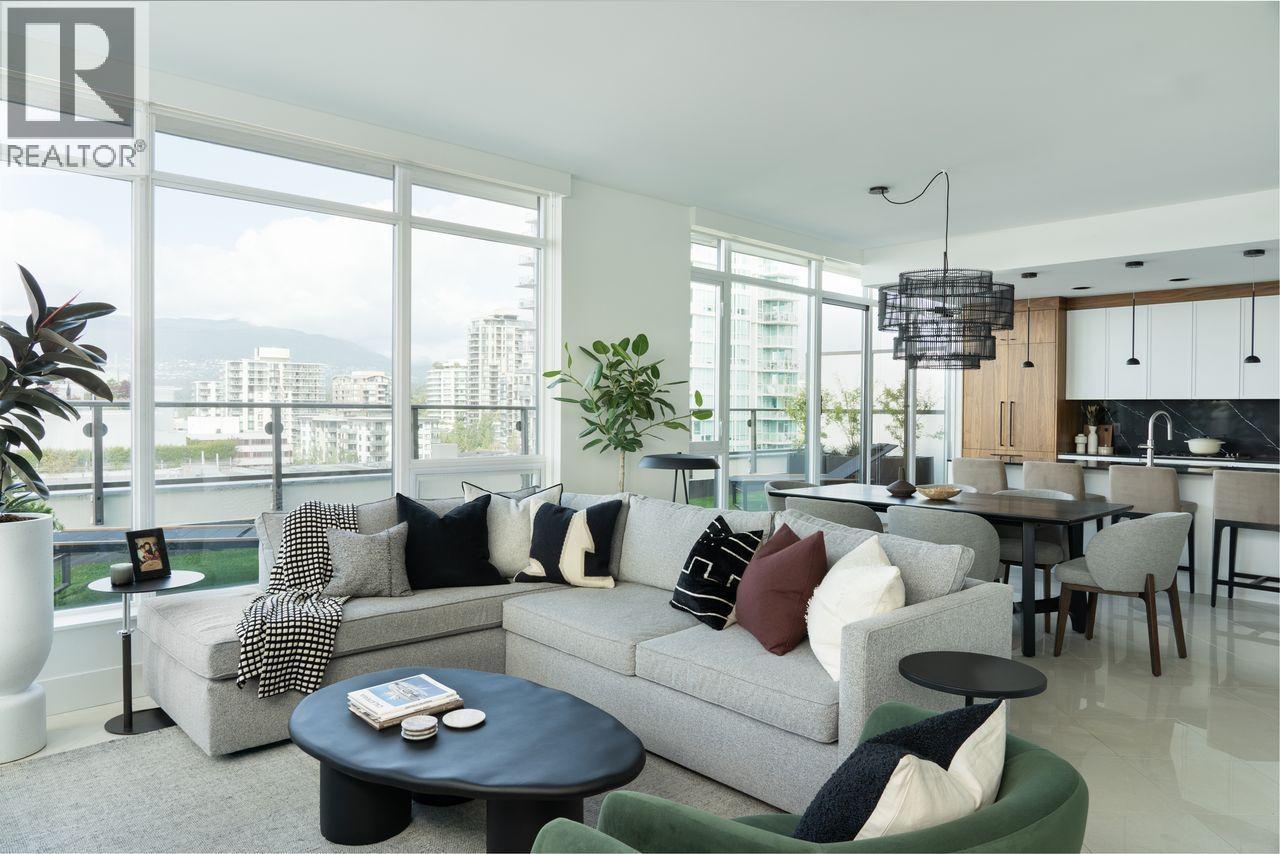 A living room with a grey couch and a black coffee table.