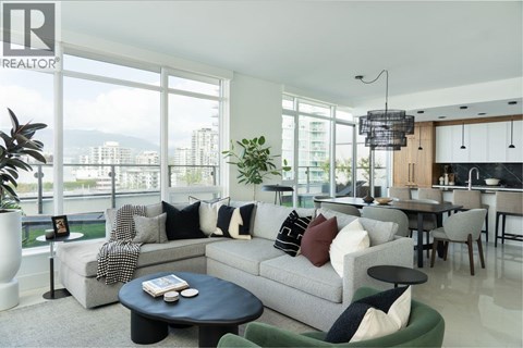A living room with a grey couch and a black coffee table.