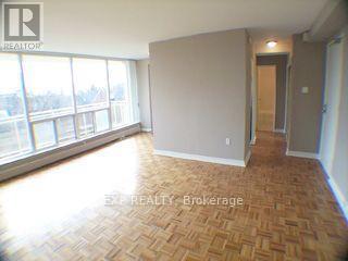 A room with a wooden floor and a large window.