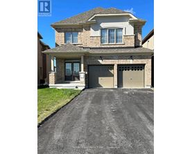 A house with a garage and a driveway in front of it.