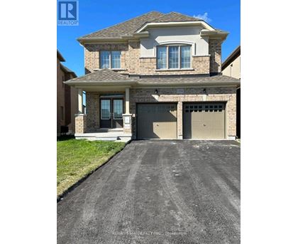 A house with a garage and a driveway in front of it.