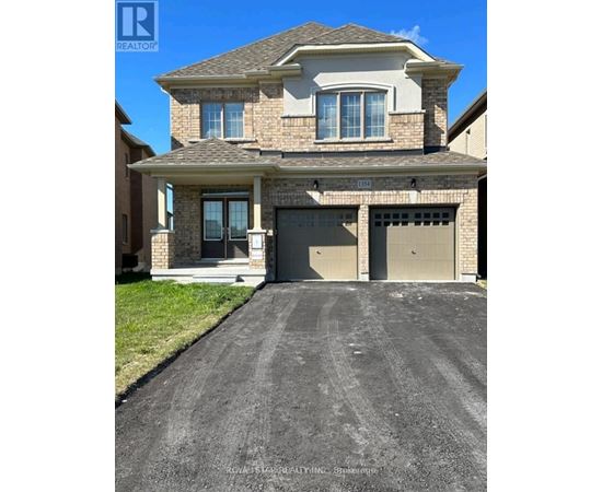 A house with a garage and a driveway in front of it.