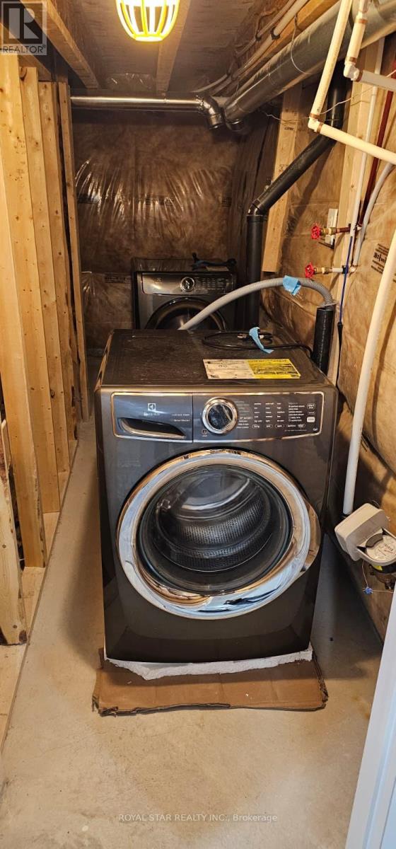 A black washing machine in a small, enclosed space.