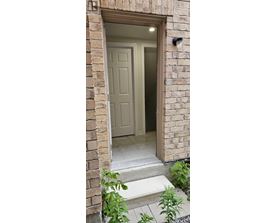A white door is open to a hallway.