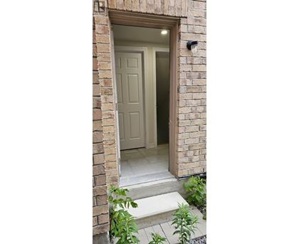 A white door is open to a hallway.