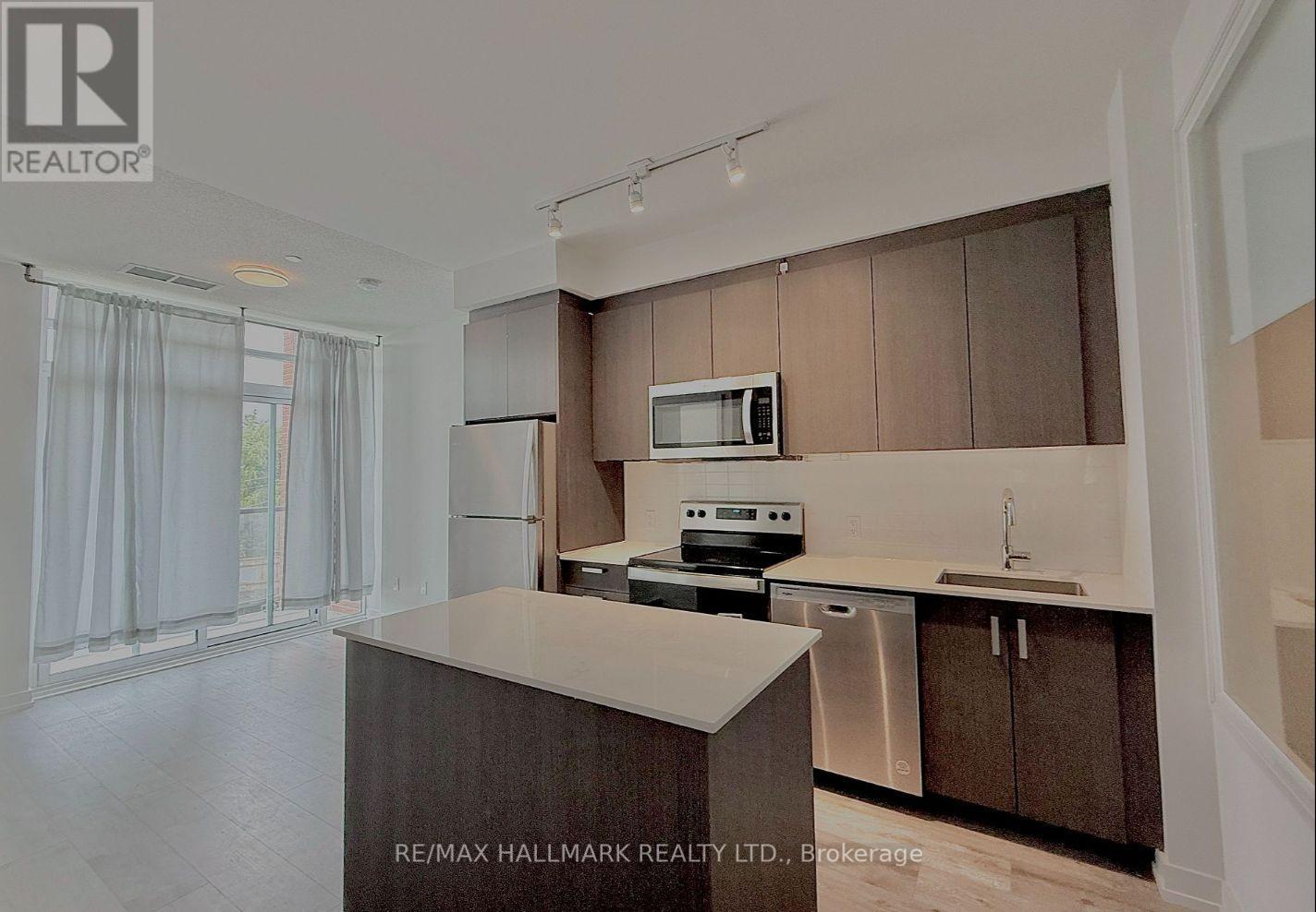A kitchen with brown cabinets and a white countertop.