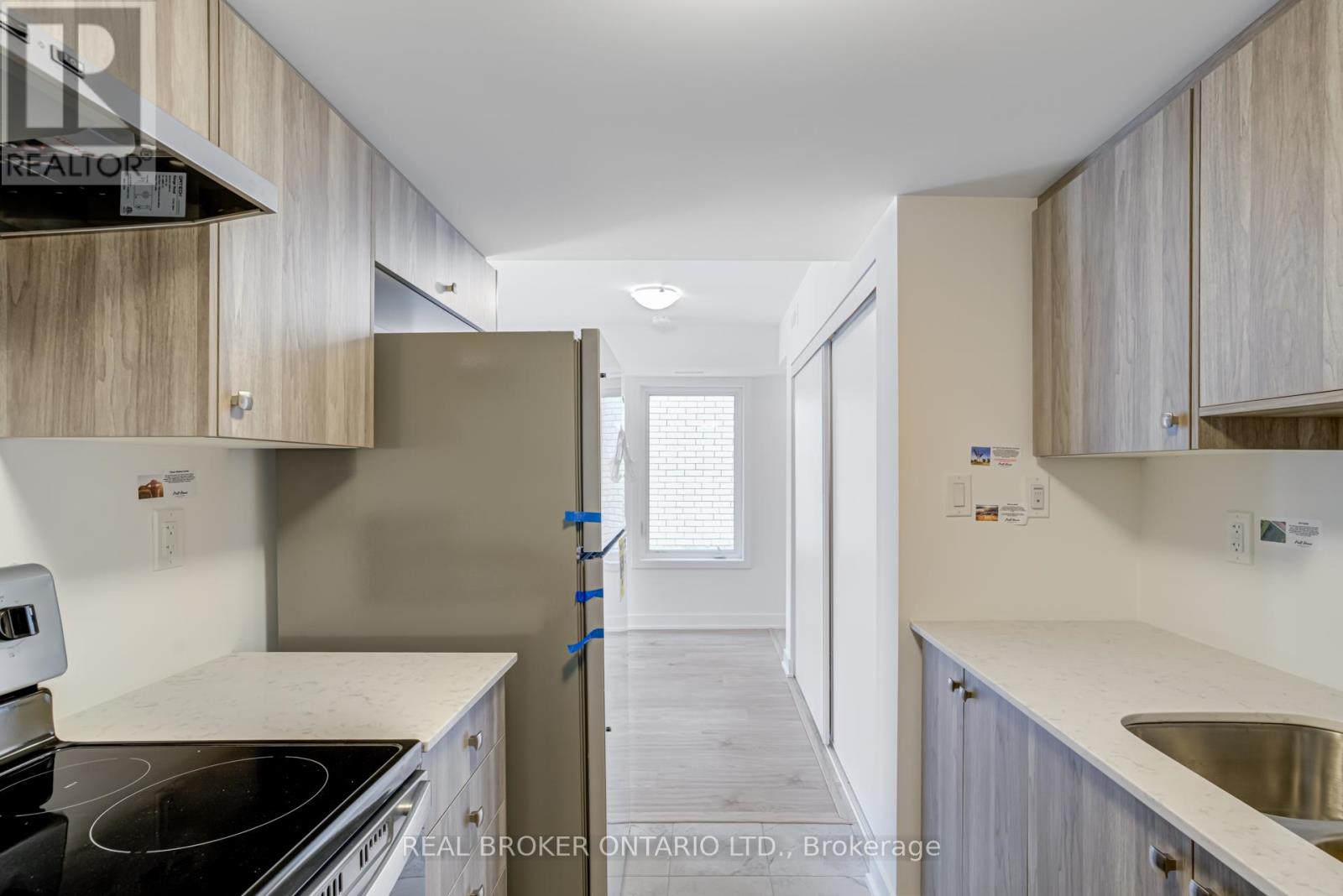 A kitchen with a stove top oven and a sink.