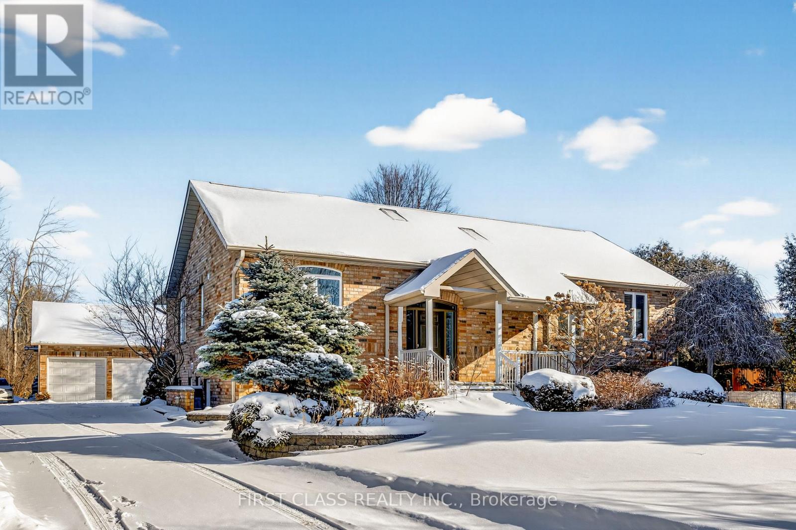 A house with a snow-covered front yard.