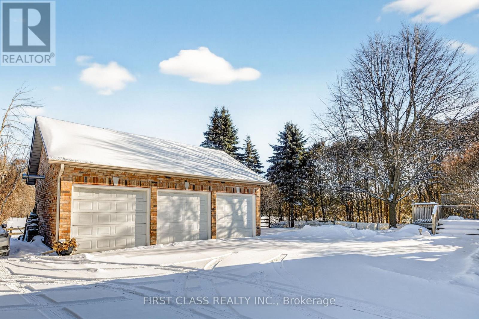 A house with a snow-covered roof and garage doors.