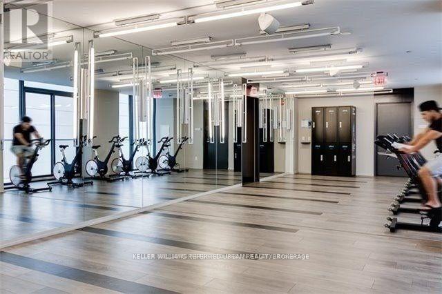 A gym with exercise bikes and a person riding one.