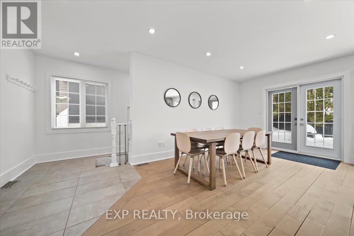 A dining room with a table set for six with chairs around it.