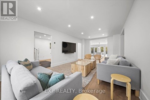 A living room with a grey couch and a wooden coffee table.