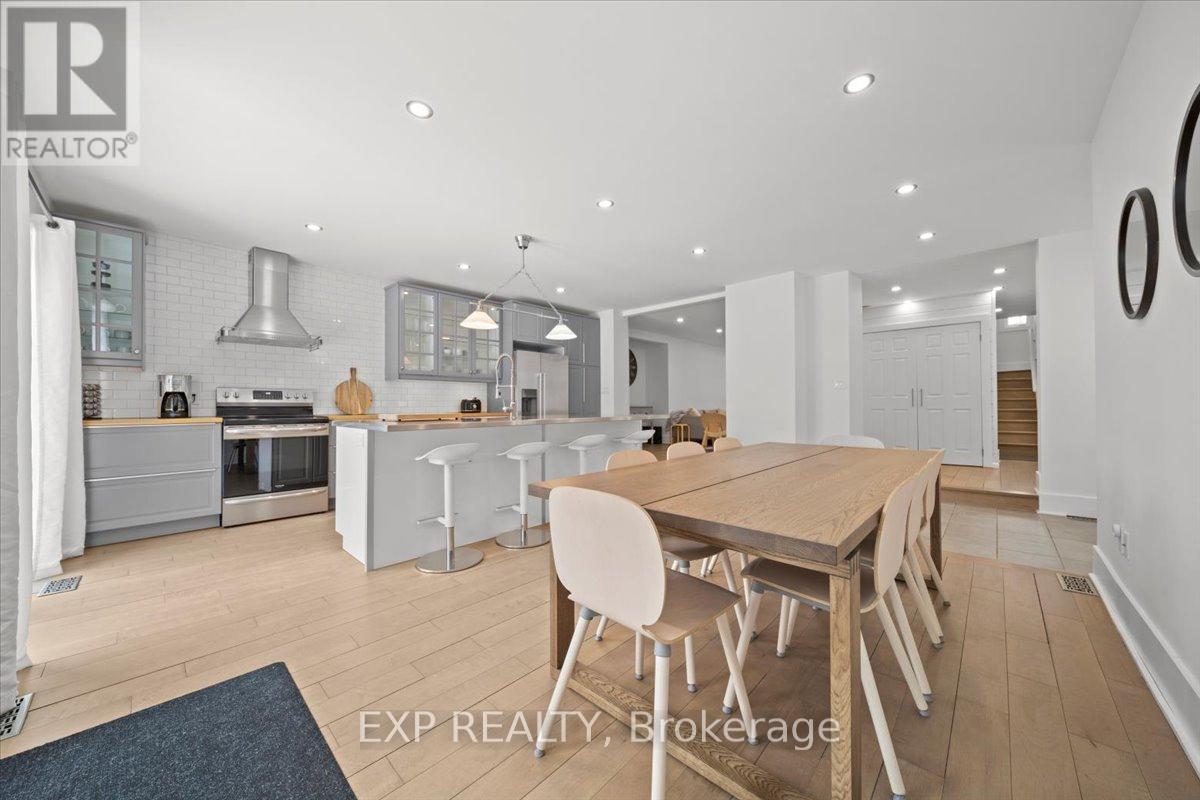 A modern kitchen with a dining table and chairs.