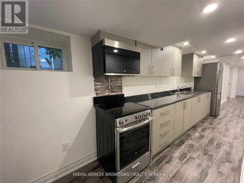 A modern kitchen with a stove top oven and a microwave above it.