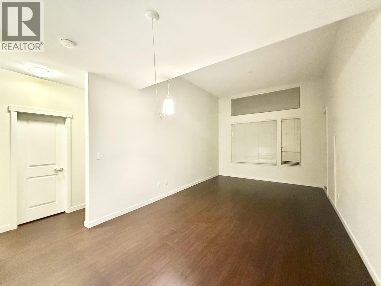 A room with wooden floors and white walls.