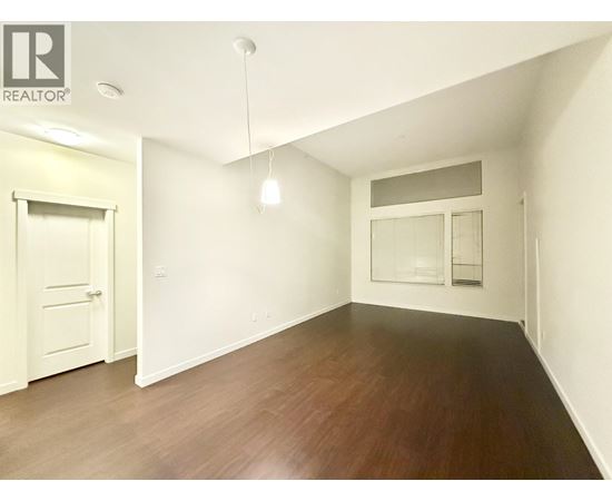 A room with wooden floors and white walls.