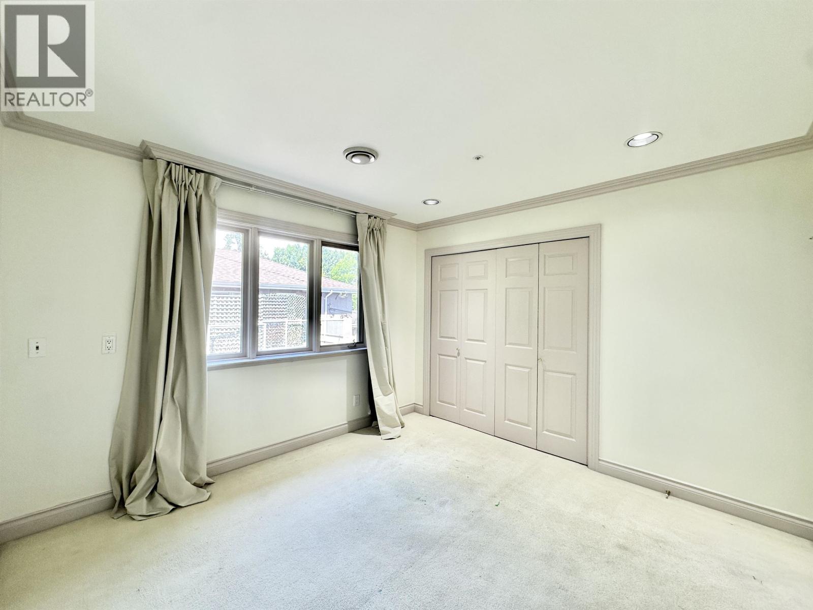 A bedroom with a window and a door is available for rent.