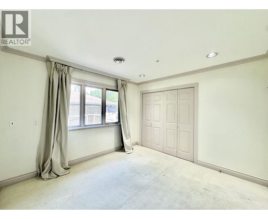 A bedroom with a window and a door is available for rent.