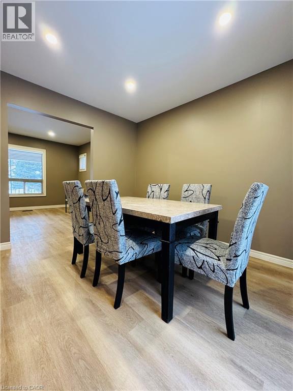 A dining room with a table and chairs.