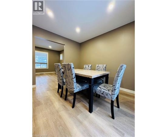 A dining room with a table and chairs.