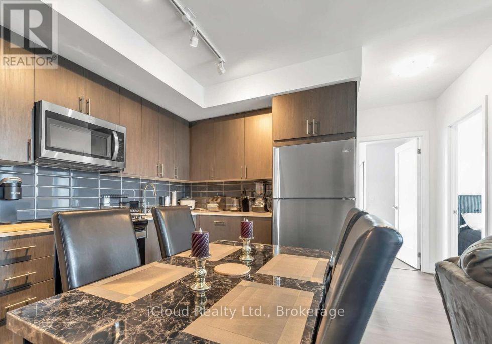 A modern kitchen with a dining table set for four.